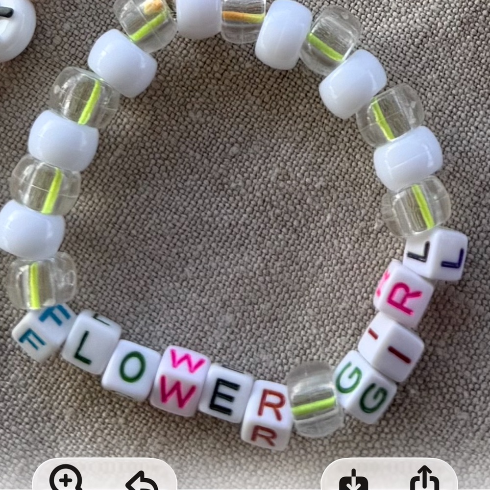 Flower girl with multi colored letter beads. White and clear beads as well .